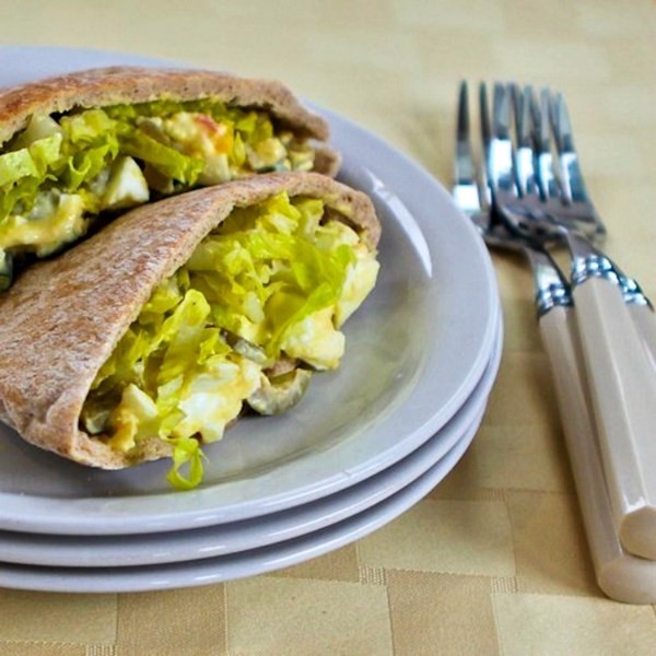 Egg salad in pita with green olives, green onions, and Dijon