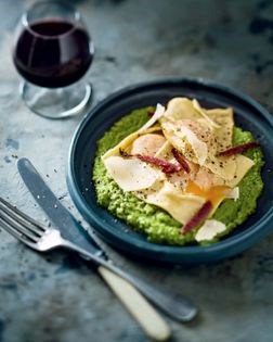 Egg-yolk ravioli with pea purée and crispy bacon