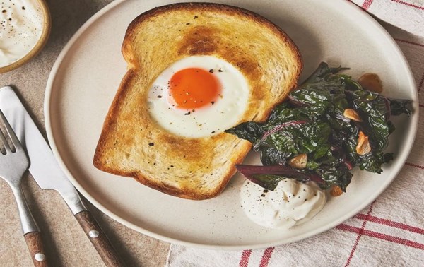 Eggs in a basket with smoky chard