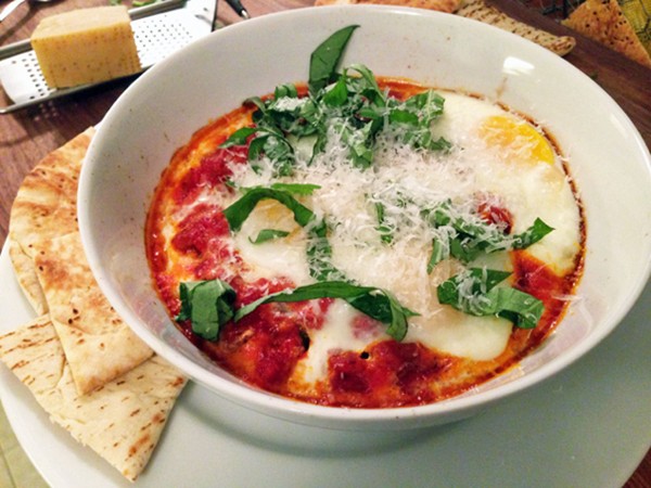 Eggs in tomato sauce with sausage and basil