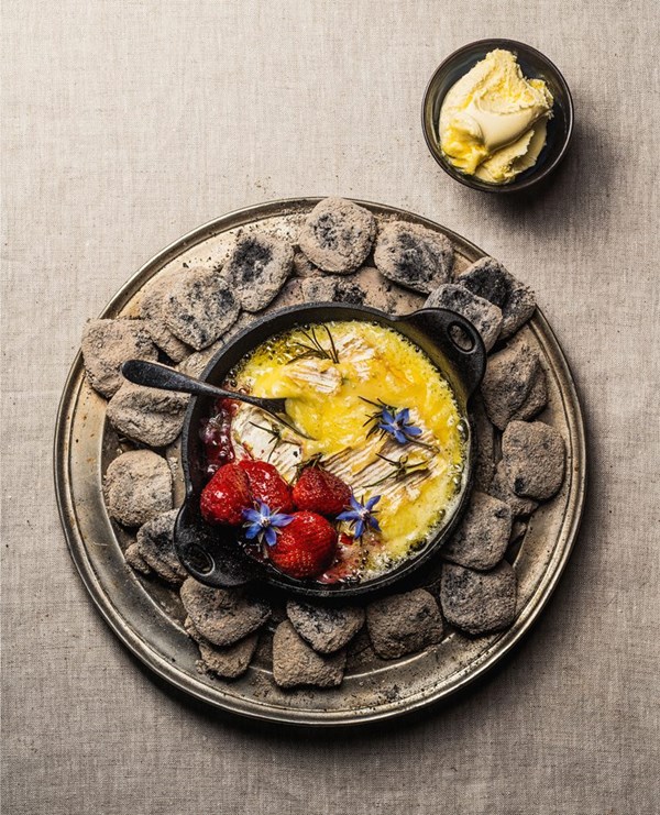 Ember-baked cheese with strawberries & honey