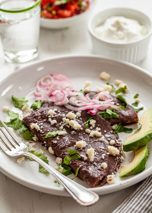 Enfrijoladas with black beans, avocado and cotija
