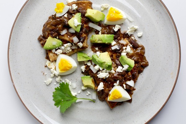 Enfrijoladas with egg, avocado and onion 
