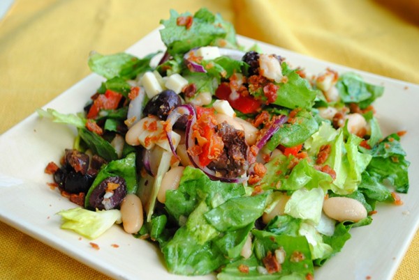 Escarole salad with provolone, warm white beans, and prosciutto crisps
