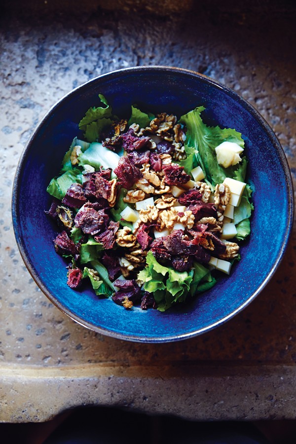 Escarole with confit duck gizzards, Comté, and walnuts