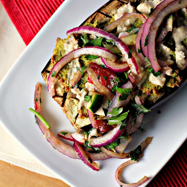 Falafel-stuffed eggplant with tahini sauce and tomato relish