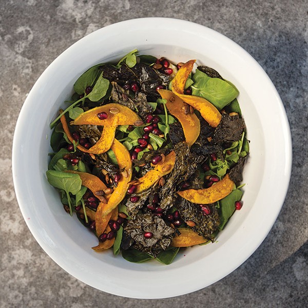 Fall salad with roasted butternut squash, kale chips, and pomegranate seeds