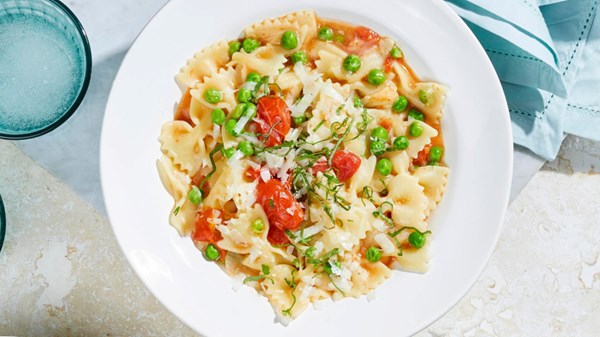 Farfalle with burst cherry tomatoes, basil, and peas