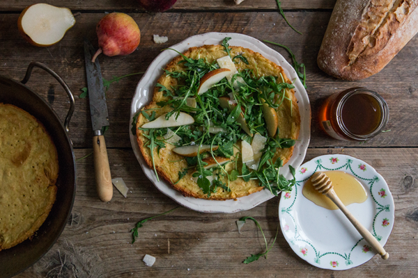 Farinata with arugula, pear, honey, and pecorino