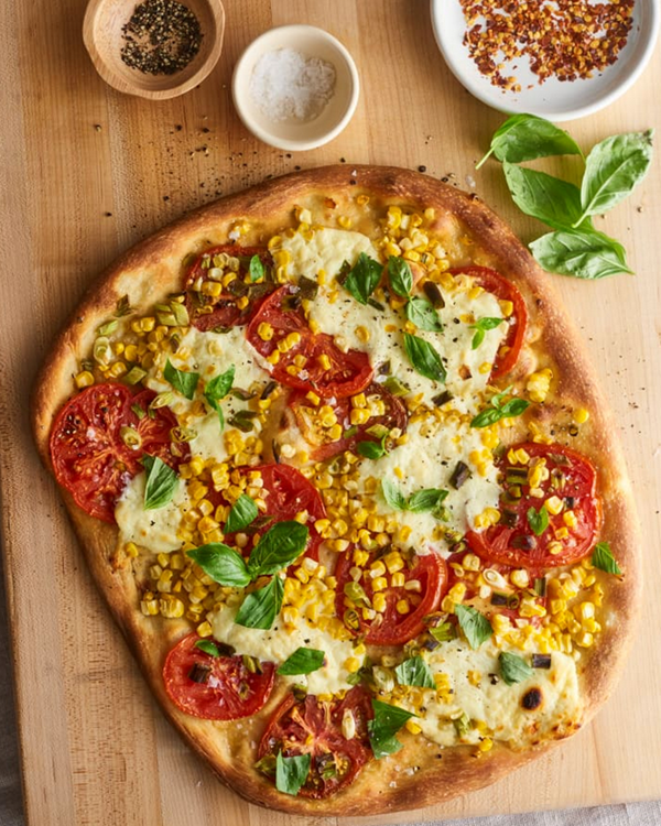 Farm-stand pizza with tomatoes, corn, and basil
