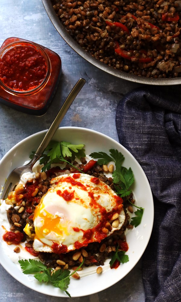 Farro and lentil mujaddara with harissa, toasted pine nuts, and a fried egg