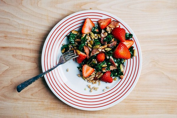 Farro, kale, and strawberry salad with bacon and chili-dusted pepitas