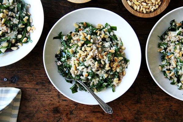 Farro with greens, tahini sauce, and toasted pine nuts