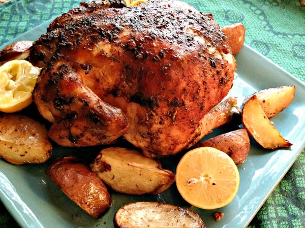 Fennel and cinnamon-rubbed roast chicken and lemons with potato wedges