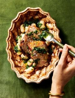 Fennel-rubbed pork shoulder with creamy white beans and herb oil