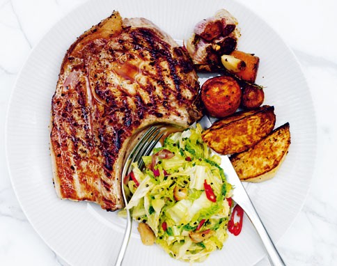 Fennel-salted pork chops with roast carrot and swede, and spicy cabbage