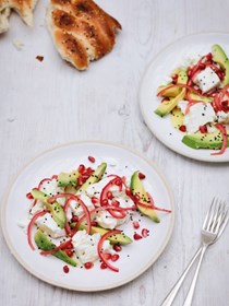 Feta and avocado salad with red onions, pomegranate and nigella seeds