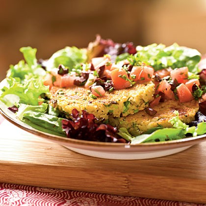 Feta and green onion couscous cakes over tomato-olive salad