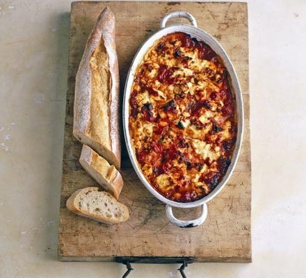 Feta baked with tomato and oregano