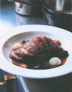 Fillet of salmon poached in duck fat, served with roasted scallops, fondant potatoes and red wine sauce