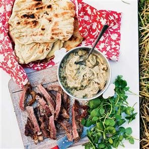 Fired flatbreads with sliced steak and baba ghanoush