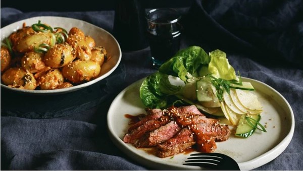 Flat iron beef with spring onion and gochujang sauce, Maori potato kimchi salad and nashi salad