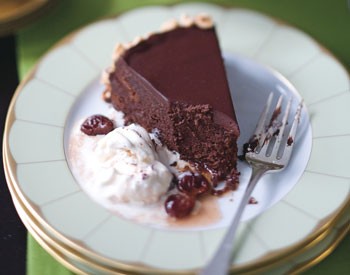Flourless chocolate cake with toasted hazelnuts and brandied cherries