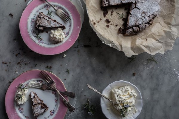 Flourless chocolate cake with whipped rosemary cream