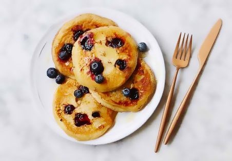 Fluffy pancakes with cream cheese and blueberries
