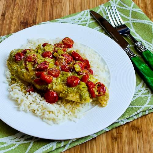 Foil-wrapped grilled tilapia packets with pesto, tomatoes, and green onions