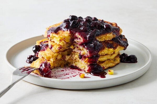 Fresh corn pancakes with blueberry sauce
