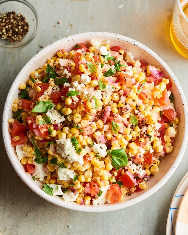 Fresh corn salad with tomato, basil, and feta