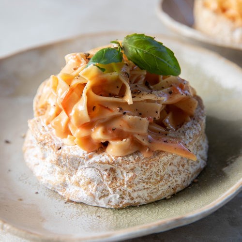 Fresh fettuccine in Camembert wheels with creamy confit tomato sauce