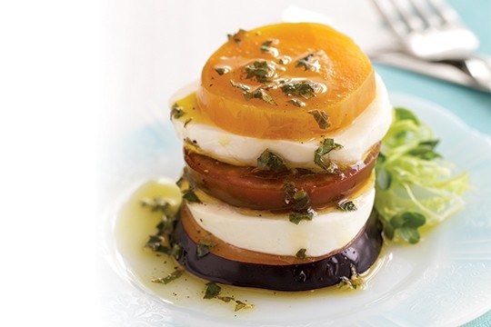 Fresh mozzarella, plum, and kumato stacks with lemon-herb drizzle