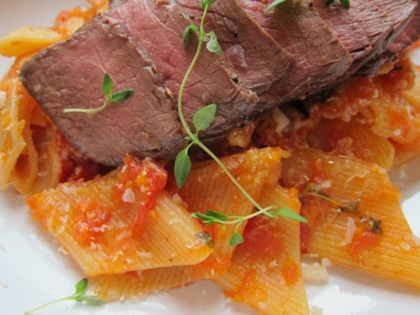 Fresh rigatoni with marinara and steak