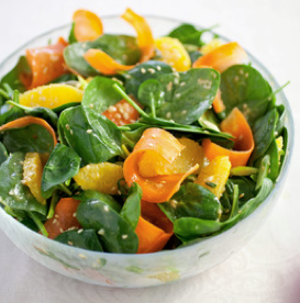 Fresh spinach salad with carrot, orange, and sesame