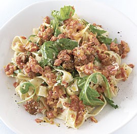 Fresh tagliatelle with sausage, red peppers, and arugula