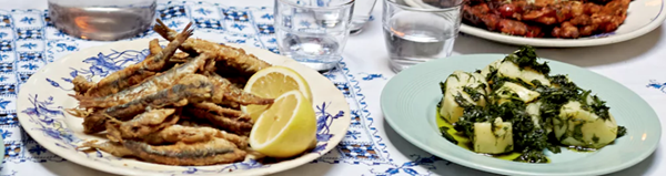 Fried anchovies with lemon, potato and chopped herb salad