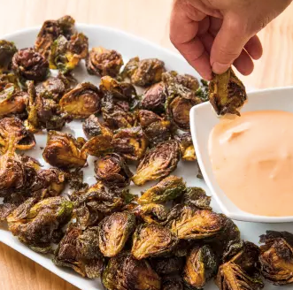 Fried Brussels sprouts with Sriracha dipping sauce
