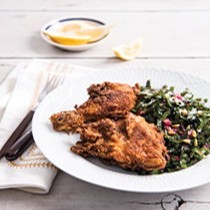 Fried chicken and Swiss chard salad with pine nuts and lemon