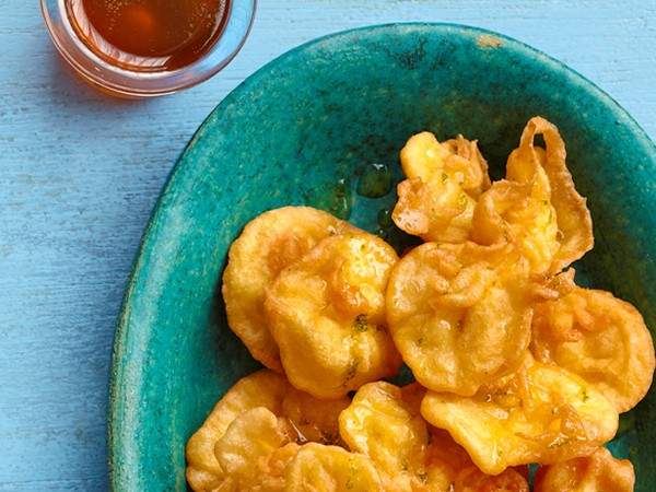 Fried dough puffs with lime syrup