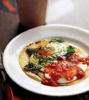 Fried eggs on corn tortillas with two salsas (Huevos divorciados)