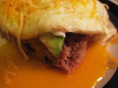 Fried eggs on toast with cheddar and avocado