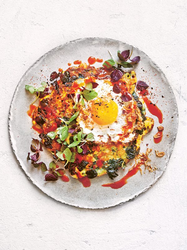 Fried eggs with corn fritters and chilli sauce
