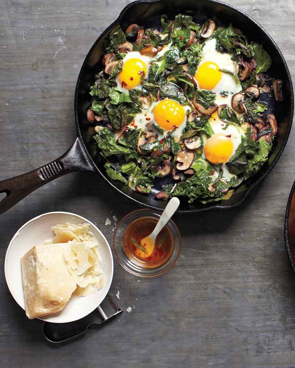 Fried eggs with greens and mushrooms