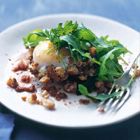Fried eggs with rocket and torn bread