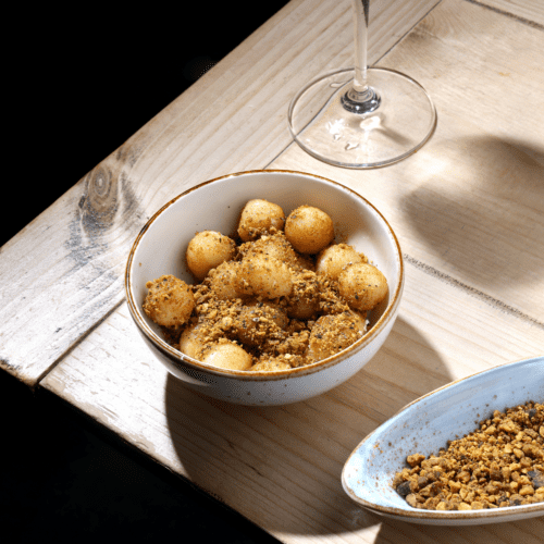 Fried goat cheese with pistachio dust, pepper, and vanilla honey