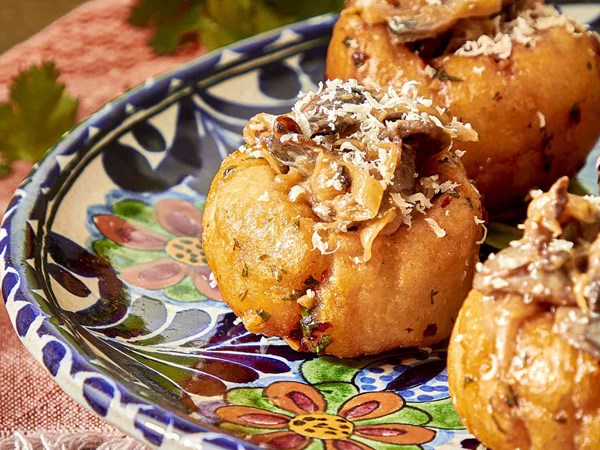 Fried masa pockets with caramelized onion and mushroom filling (Cazuelitas)