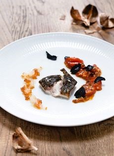 Fried mullet with baked grape tomatoes, marinated sago pearls, and black garlic