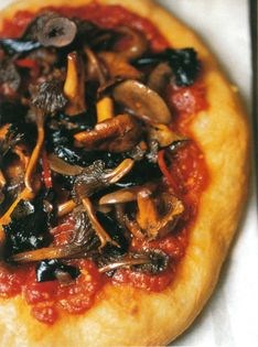 Fried pizza with mixed mushrooms and tomatoes